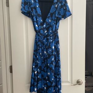 Beautiful knee-length floral wrap dress.  Pleated skirt, adjustable tie waist.